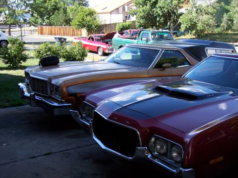 1972 Ford Ranchero - Two Ford Rancheros are parked in a driveway, with the front vehicle being a maroon 1972 model.