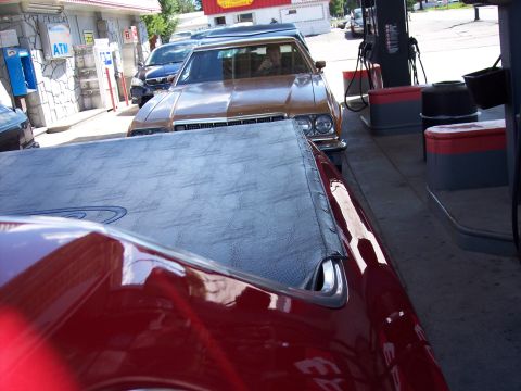 1972 Ford Ranchero - A 1972 Ford Ranchero is at the gas pumps, with another vehicle in the foreground.