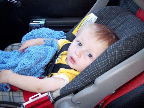 1972 Ford Ranchero - A young child is secured in a car seat, wrapped in a blue blanket.