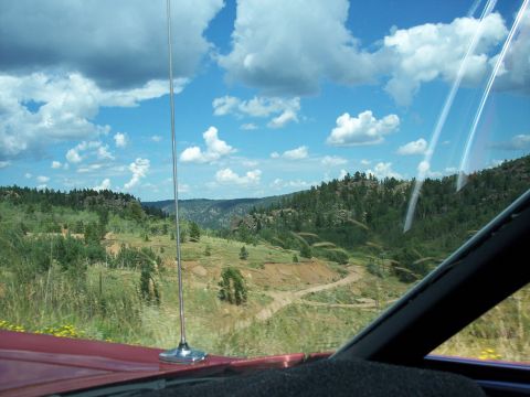 1972 Ford Ranchero - View from inside a vehicle looking out at a scenic landscape with rolling hills and scattered trees.