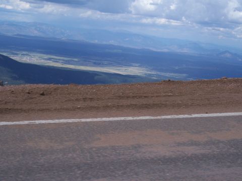 1972 Ford Ranchero - A scenic view from a mountain road shows a vast valley and distant mountain ranges under a dramatic sky.