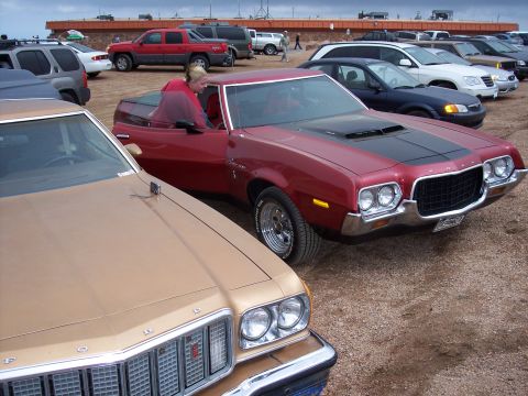 1972 Ford Ranchero - Two 1972 Ford Rancheros are parked side-by-side in a gravel lot under an overcast sky.