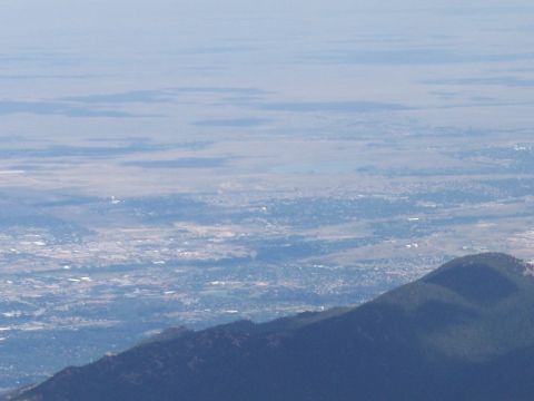 1972 Ford Ranchero - A wide view from a mountain peak shows a town in the distance, with a hazy sky overhead.