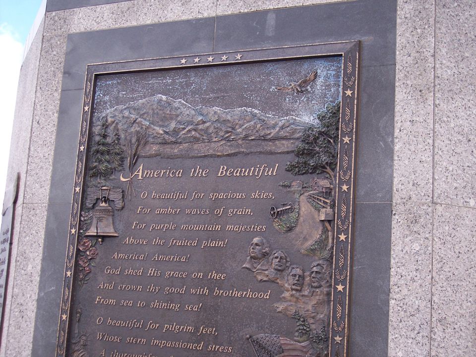Granite-framed bronze monument plaque of America the Beautiful poem