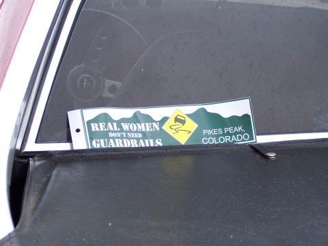 1972 Ford Ranchero - A sticker on a car window advertises Pikes Peak, Colorado, with the slogan 'Real Women Don't Need Guardrails'.