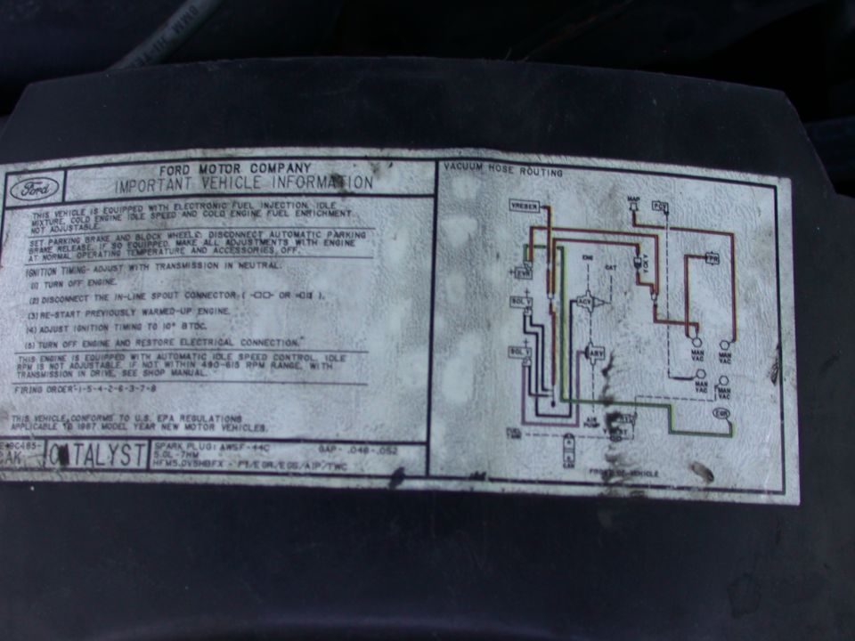 Faded 1987 Ford 5.0L vehicle information decal with vacuum hose routing diagram