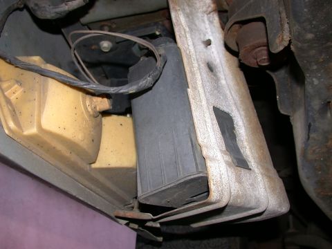1987 Lincoln Town Car - Close-up view of a vacuum canister and its mounting bracket, likely related to emissions or engine systems.