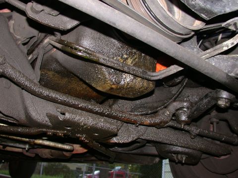 1987 Lincoln Town Car - Visible oil leaks on the underside of a vehicle, likely from the engine or transmission.