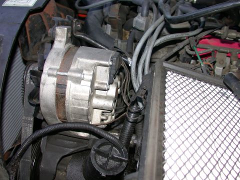 1987 Lincoln Town Car - Close-up view of engine components, focusing on the alternator and associated wiring.