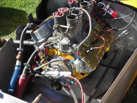 1998 Ford Crown Victoria - built race engine with tall stacked velocity intakes, yellow finned heads and braided fuel lines mounted in a bare-metal chassis.