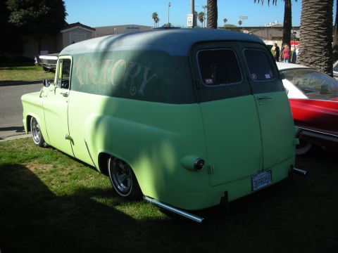 1998 Ford Crown Victoria - lowered green two-tone panel delivery van with VICTORY hand-lettered on the side panel sits on grass at a show.