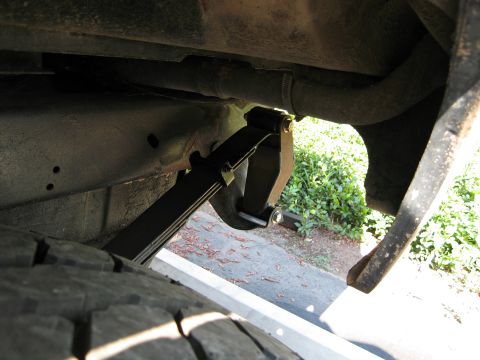 1986 Ford Bronco - Close-up of a vehicle's leaf spring suspension system and tire.