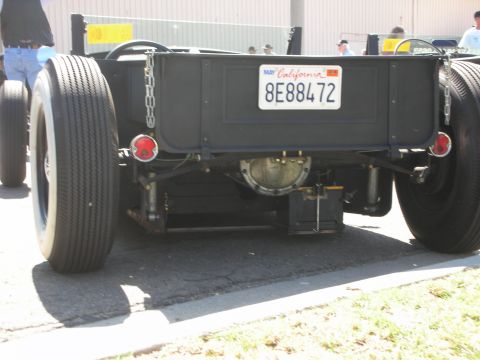 1998 Ford Crown Victoria - Rear of a black hot rod pickup with exposed differential, big tires and a California plate reading 8E88472.
