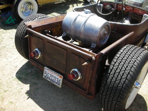 1998 Ford Crown Victoria - Rear view of a rat rod pickup showing the rusty tailgate, spiked taillights, keg fuel tank and California license plate 5GZC036.