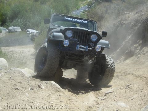 1987 Suzuki Samurai - This 1987 Jeep CJ-7 navigates a rocky, dusty off-road trail.