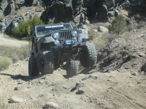 1987 Suzuki Samurai - A modified Jeep CJ-7 navigates a rocky, off-road trail.