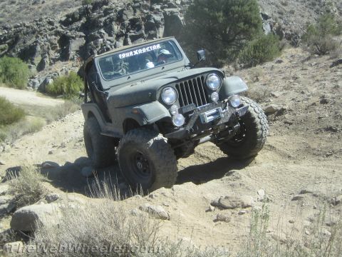 1987 Suzuki Samurai - Jeep CJ-5 tackles a challenging off-road trail with large tires and a winch.
