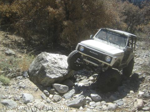 1987 Suzuki Samurai - Suzuki Samurai navigating a rocky trail, demonstrating its off-road capability.