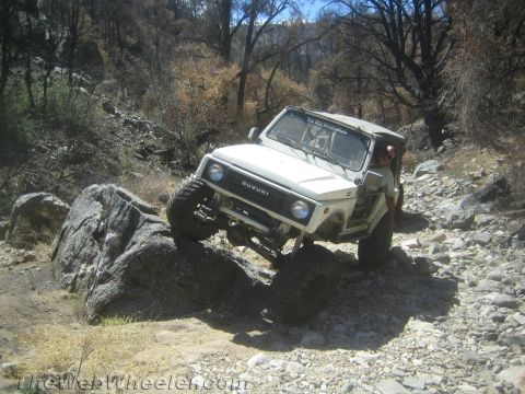 1987 Suzuki Samurai - Suzuki Samurai tackling a challenging rocky trail, demonstrating its off-road capability.