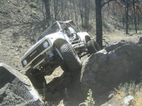 1987 Suzuki Samurai - A Suzuki Samurai navigates a rocky trail, demonstrating its off-road capabilities.