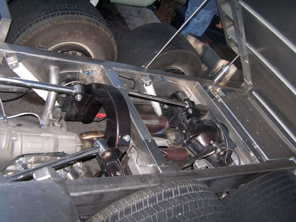 Close-up of a custom vehicle chassis showing suspension, drivetrain, and tires