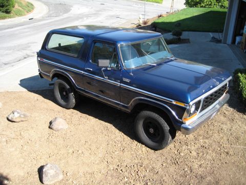 Blue 1978 Ford Bronco parked on dirt lot