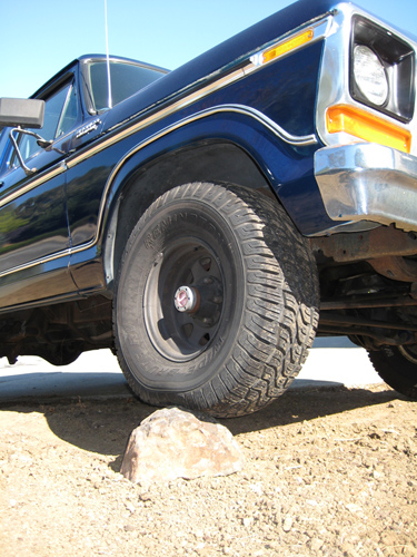 1978 Ford Bronco front fender and wheel on rocky terrain