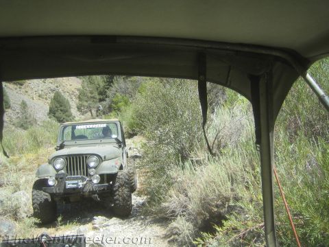 1987 Suzuki Samurai - A Jeep CJ-5 navigates a trail, with another vehicle visible ahead.