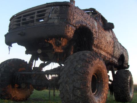 1995 Ford F-550 - This heavily modified truck is caked in mud, obscuring its original details and year.
