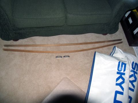 1978 Ford Bronco - Wooden trim pieces and metal clips are laid out on a carpeted floor.