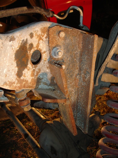 1996 Ford F-150 - Close-up view of a heavily rusted frame bracket and suspension components, likely from an older truck.