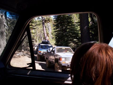 1989 Ford Bronco - Off-road convoy driving on a dirt road through a forest.