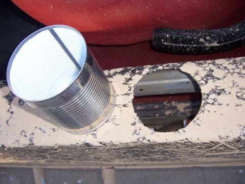 1991 Ford Bronco - A tin can is placed in a freshly cut hole on a vehicle's interior panel.