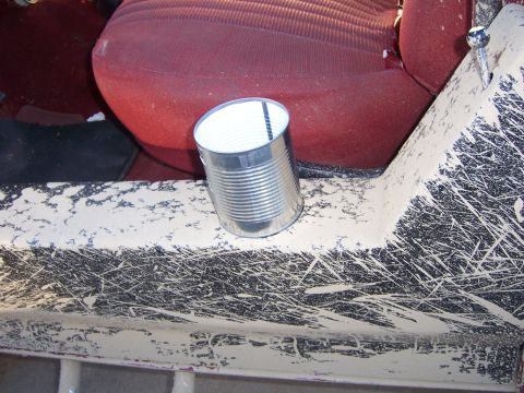 1991 Ford Bronco - Muddy interior door panel with a tin can and red seat visible.