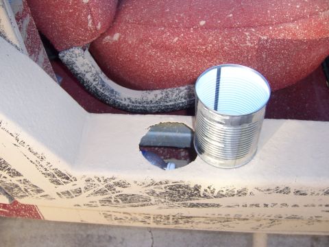 1991 Ford Bronco - A tin can is placed on the interior panel of a vehicle, next to a circular opening.