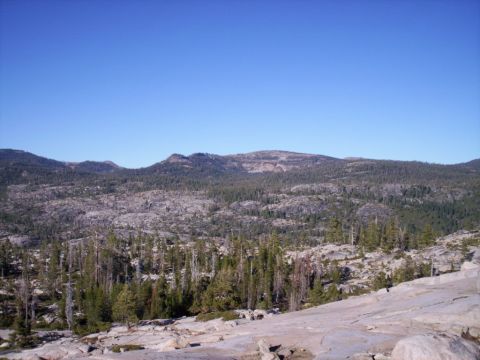 1989 Ford Bronco - A wide view of a mountainous area with sparse vegetation and a clear sky above.