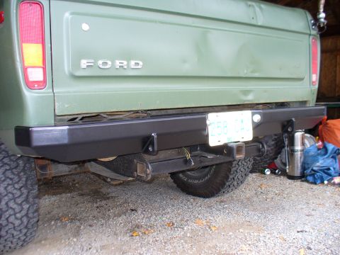 1978 Ford Bronco - The rear of a green Ford truck is shown with a custom black bumper and a license plate attached.