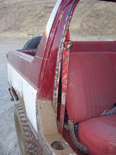 1991 Ford Bronco - This vehicle appears to have recently been off-roading, as evidenced by the significant amount of mud covering its interior and exterior.