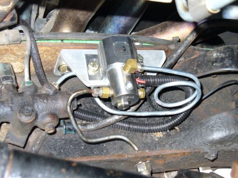 1978 Ford Bronco - Close-up of a vehicle's undercarriage showing a line-lock solenoid and associated plumbing.