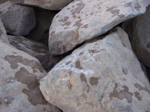 1991 Ford Bronco - A close-up view of a pile of large rocks, some of which are wet and have dark patches.