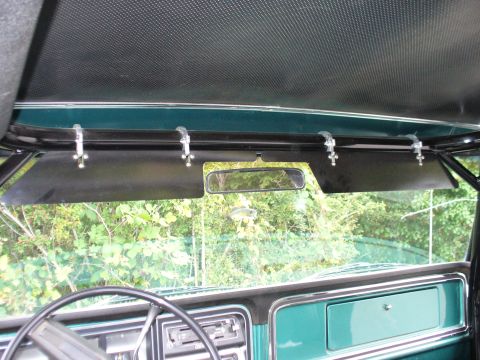 1978 Ford Bronco - Interior view of a vehicle, focusing on the sun visors and rearview mirror.