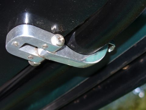 1978 Ford Bronco - A detailed view of a vehicle's interior door latch assembly, showing its construction and mounting.