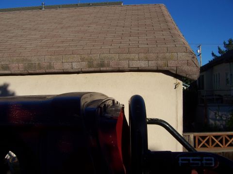 1991 Ford Bronco - A close-up view of a roll bar with "F5B" visible on a dark red vehicle.
