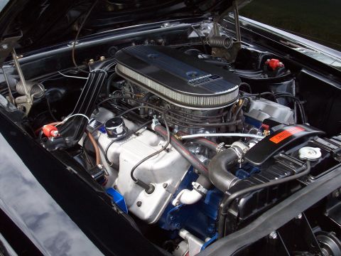 1997 Ford Mustang - Close-up of a V8 engine in a black vehicle, showing the air cleaner and radiator.
