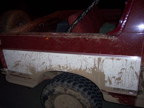 1991 Ford Bronco - This vehicle appears to have been driven through a muddy area, leaving significant splatter on its exterior.