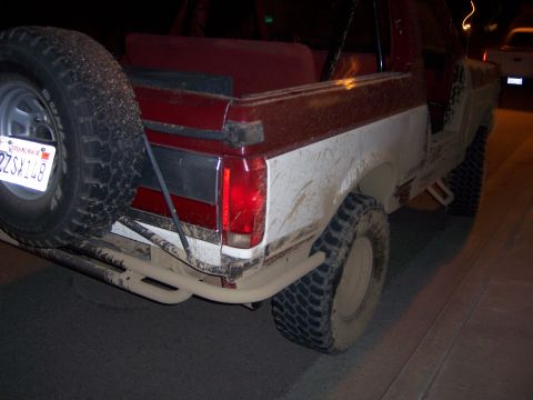 1991 Ford Bronco - This two-tone Ford Bronco is caked in mud, suggesting it has seen some off-road action.
