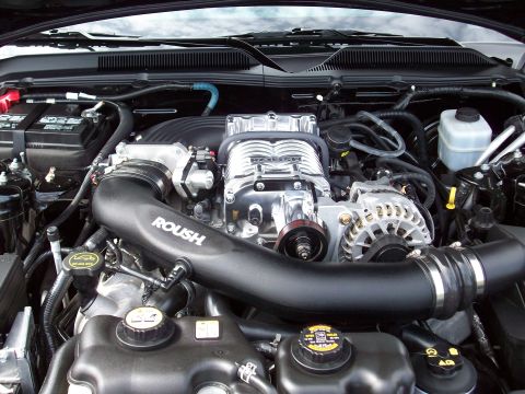 1997 Ford Mustang - Engine bay features a prominent Roush supercharger and intake system.