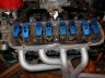 1980 Ford Bronco - Close-up view of an engine's intake manifold and exhaust system.