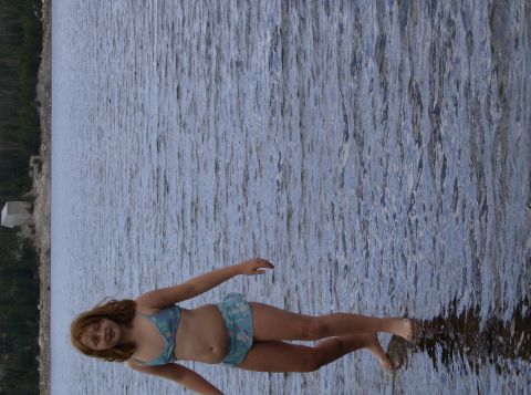 1986 Ford Bronco - Girl in a blue bikini stands at the edge of a large body of water.