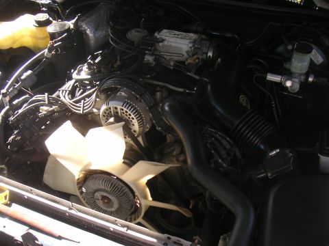 1996 Ford Crown Victoria - Close-up view of the engine compartment, showing various mechanical parts and wiring.